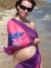 Sexy pregnant chick strips from her cute red top and panties.