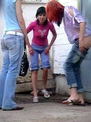 A group of young hotties pee and talk together