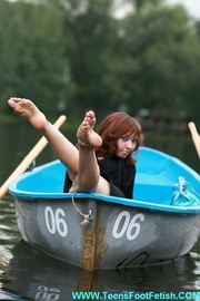 Erotic redhead teen bimbo willingly expose her sexy foot while boating alone on the lake.