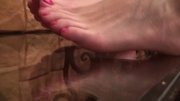 Erotic xxx video of cute teen girl exposing her sexy feet with pink nails on toes.