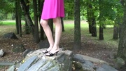 Petite body erotic teen in sexy pink dress sitting on the rocks and exposing her sexy feet.